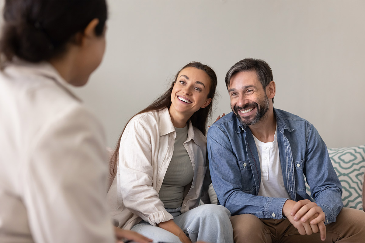 A couple engages in conversation with a therapist on a couch, focusing on healing and new possibilities for the New Year.